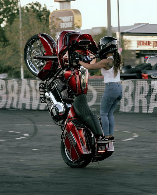 Image of stunt rider Andrea Tuia on a red motorcycle doing wheelie